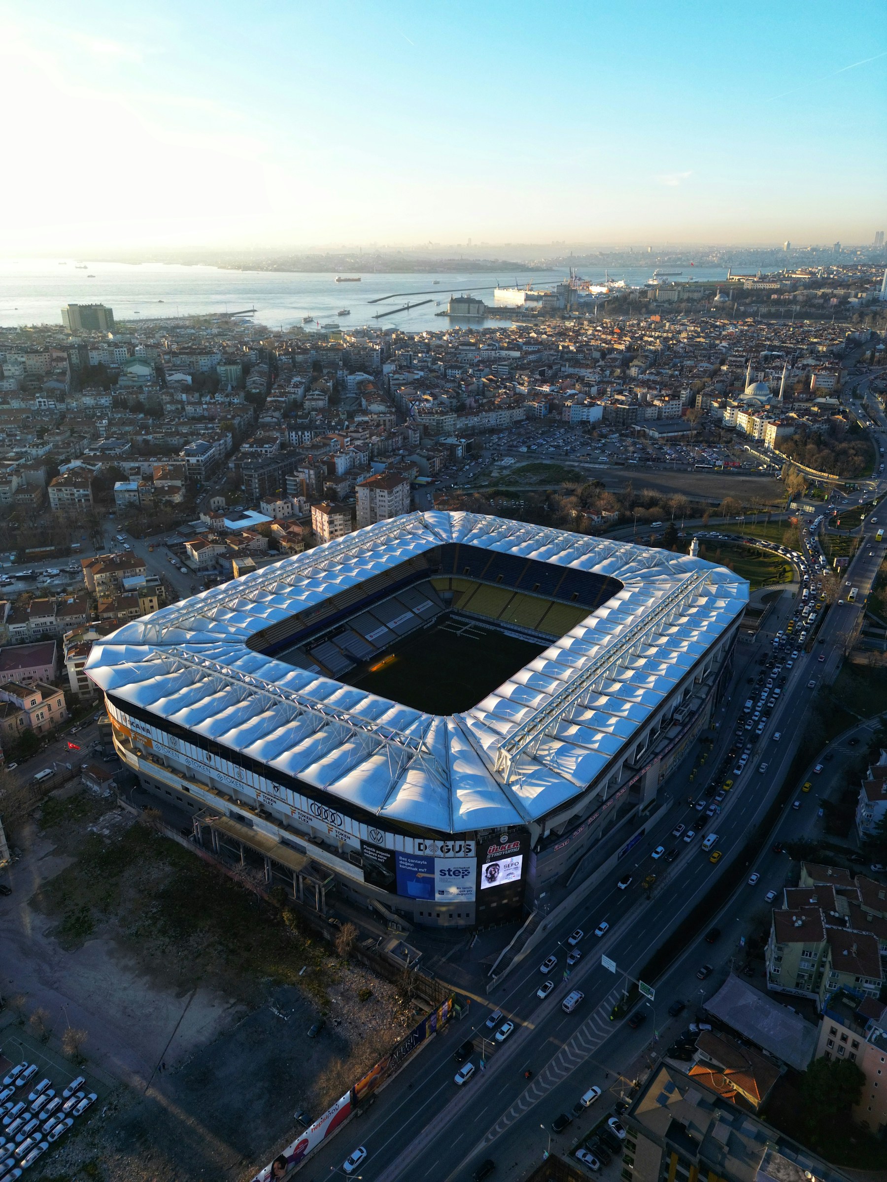 Aerial view of a football stadium, its pitch and surrounding city streets